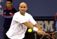 Andre Agassi returns a backhand during the first set Tuesday, September 2, 2003 at the U. S. Open in New York. Agassi, top ranked in the men's division, dropped the first set to Taylor Dent in a match that was twice delayed by rain. (Photo by A. Messerschmidt/Getty Images)