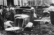 July 1936: Burned out cars on a street after Franco's Nationalist uprising was defeated in Barcelona at the outset of the Spanish Civil War. The city eventually fell to the Nationalists in 1939. (Photo by Keystone/Getty Images)