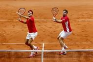 LILLE, FRANCE - NOVEMBER 22: Roger Federer of Switzerland and Stanislas Wawrinka of Switzerland in action against Richard Gasquet of France and Julien Benneteau of France in the doubles during day two of the Davis Cup Tennis Final between France and Switzerland at the Stade Pierre Mauroy on November 22, 2014 in Lille, France. (Photo by Julian Finney/Getty Images)
