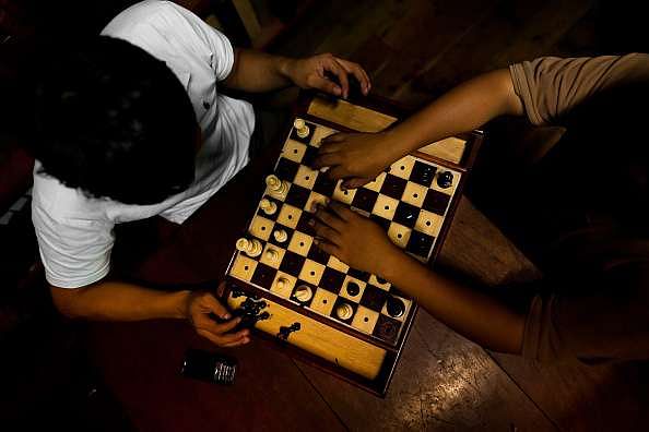 Visually impaired chess player Darpan Inani shows his opponents he