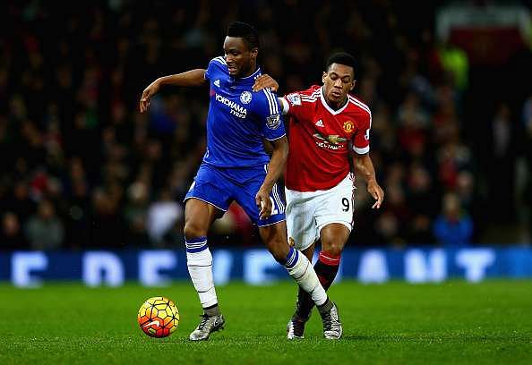 MANCHESTER, ENGLAND - DECEMBER 28:  John Obi Mikel of Chelsea holds off a challenge from Anthony Martial of Manchester United during the Barclays Premier League match between Manchester United and Chelsea at Old Trafford on December 28, 2015 in Manchester, England.  (Photo by Clive Mason/Getty Images)