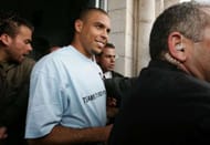RAMALLAH, WEST BANK - MAY 16: Brazilian soccer star Ronaldo (2nd L), a Real Madrid player, is accompanied by bodyguards as he leaves a center for disadvantaged youth founded by the UN May 16, 2005 in the West Bank town of Ramallah. Ronaldo, a UN goodwill ambassador, is on a one-day visit to projects in the West Bank before watching Palestinian and Israeli youngsters play in a football tournament in his honor near Tel Aviv. (Photo by David Silverman/Getty Images)