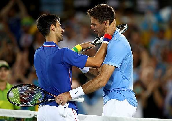 RIO DE JANEIRO, BRAZIL - AUGUST 07:  Juan Martin Del Potro of Argentina is congratulated by Novak Djokovic of Serbia after his victory in their singles match on Day 2 of the Rio 2016 Olympic Games at the Olympic Tennis Centre on August 7, 2016 in Rio de Janeiro, Brazil.  (Photo by Clive Brunskill/Getty Images)