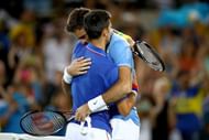 RIO DE JANEIRO, BRAZIL - AUGUST 07: Juan Martin Del Potro of Argentina is congratulated by Novak Djokovic of Serbia after his victory in their singles match on Day 2 of the Rio 2016 Olympic Games at the Olympic Tennis Centre on August 7, 2016 in Rio de Janeiro, Brazil. (Photo by Clive Brunskill/Getty Images)
