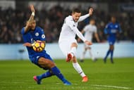 SWANSEA, WALES - FEBRUARY 12: Gylfi Sigurdsson of Swansea City shoots past Danny Simpson of Leicester City during the Premier League match between Swansea City and Leicester City at Liberty Stadium on February 12, 2017 in Swansea, Wales. (Photo by Stu Forster/Getty Images)
