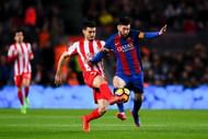 BARCELONA, SPAIN - MARCH 01: Lionel Messi of FC Barcelona competes for the ball with Sergio Alvarez of Real Sporting de Gijon during the La Liga match between FC Barcelona and Real Sporting de Gijon at Camp Nou stadium on March 1, 2017 in Barcelona, Spain. (Photo by David Ramos/Getty Images)