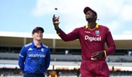 BRIDGETOWN, BARBADOS - MARCH 09: West Indies captain Jason Holder tosses the coin alongside England captain Eoin Morgan ahead of the 3rd One Day International between the West Indies and England at Kensington Oval on March 9, 2017 in Bridgetown, Barbados. (Photo by Gareth Copley/Getty Images)