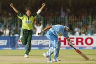 LAHORE, PAKISTAN - MARCH 24: Mohammad Sami (L) of Pakistan celebrates after dismissing Rahul Dravid of India during the fifth Pakistan v India one-day international match played at the Gadaffi Stadium on March 24, 2004 in Lahore, Pakistan. (Photo by Scott Barbour/Getty Images)