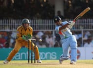 NAGPUR, INDIA - OCTOBER 14: Robin Uthappa of India hits to mid off with Adam Gilchrist of Australia looking on during the sixth one day international match between India and Australia at at the VCA Stadium on October 14, 2007 in Nagpur, India. (Photo by Hamish Blair/Getty Images)