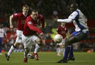 MANCHESTER, UNITED KINGDOM - JANUARY 27: Wayne Rooney of Manchester United looks for a way past Sol Campbell of Portsmouth during the FA Cup sponsored by E.ON Fourth Round match between Manchester United and Portsmouth at Old Trafford on January 27, 2007 in Manchester, England. (Photo by Alex Livesey/Getty Images)