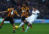 HULL, ENGLAND - DECEMBER 26: Wayne Rooney (R) of Manchester United shoots and scores his sides second goal during the Barclays Premier League match between Hull City and Manchester United at KC Stadium on December 26, 2013 in Hull, England. (Photo by Matthew Lewis/Getty Images)