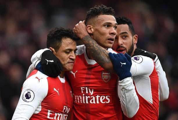 LONDON, ENGLAND - FEBRUARY 11:  Alexis Sanchez (L) of Arsenal celebrates scoring the opening goal with his team mates Kieran Gibbs (C) and Theo Walcott (R) during the Premier League match between Arsenal and Hull City at Emirates Stadium on February 11, 2017 in London, England.  (Photo by Laurence Griffiths/Getty Images)