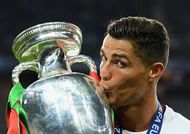 PARIS, FRANCE - JULY 10: Cristiano Ronaldo of Portugal kisses the Henri Delaunay trophy to celebrate after their 1-0 win against France in the UEFA EURO 2016 Final match between Portugal and France at Stade de France on July 10, 2016 in Paris, France. (Photo by Matthias Hangst/Getty Images)