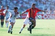17 JUN 1994: JON ANDONI GOIKOETXEA #7 OF SPAIN IS CHASED BY KO JEONG WOON #10 OF SOUTH KOREA DURING THEIR 1994 WORLD CUP MATCH AT THE COTTON BOWL IN DALLAS, TEXAS. THE GAME FINISHED TIED 2-2. Mandatory Credit: Simon Bruty/ALLSPORT