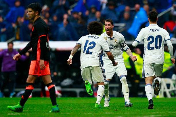 MADRID, SPAIN - APRIL 29: Marcelo (L) of Real Madrid CF celebrates scoring their second goal with teammate Sergio Ramos (2ndL) and Marco Asensio (R) during the La Liga match between Real Madrid CF and Valencia CF at Estadio Santiago Bernabeu on April 29, 2017 in Madrid, Spain.  (Photo by Gonzalo Arroyo Moreno/Getty Images)