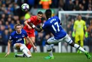 LIVERPOOL, ENGLAND - APRIL 01: Matthew Pennington of Everton (L) and Philippe Coutinho of Liverpool (C) battle for possession during the Premier League match between Liverpool and Everton at Anfield on April 1, 2017 in Liverpool, England. (Photo by Gareth Copley/Getty Images)