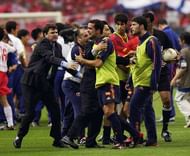 GWANGJU - JUNE 22: Spain coach Jose Antonio Camacho restrains his players from arguing with referee Gamal Ghandour after the FIFA World Cup Finals 2002 Quarter Finals match between Spain and South Korea played at the Gwangju World Cup Stadium, in Gwangju, South Korea on June 22, 2002. The match ended in a 0-0 draw after extra-time, with South Korea winning on penalties 5-3. DIGITAL IMAGE. (Photo by Shaun Botterill/Getty Images)