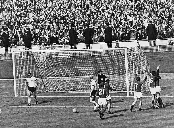The England team celebrate after Geoff Hurst scores the controversial third goal against West Germany during the World Cup final at Wembley Stadium, 30th July 1966. The goal was eventually given and England won the match 4-2. (Photo by Getty Images)