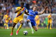 LONDON, ENGLAND - APRIL 01: Wilfried Zaha of Crystal Palace (L) is tackled by Gary Cahill of Chelsea (R) during the Premier League match between Chelsea and Crystal Palace at Stamford Bridge on April 1, 2017 in London, England. (Photo by Mike Hewitt/Getty Images)