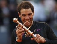 MADRID, SPAIN - MAY 14: Rafael Nadal of Spain bites the winners trophy after his win over Dominic Thiem of Austria in the final during day nine of the Mutua Madrid Open tennis at La Caja Magica on May 14, 2017 in Madrid, Spain. (Photo by Julian Finney/Getty Images)