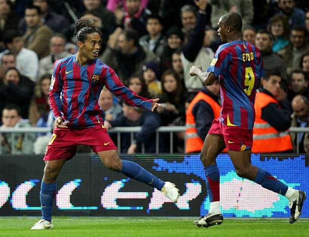 MADRID, SPAIN - NOVEMBER 19: Ronaldinho (L) of Barcelona celebrates with Samuel Eto'o after scoring a goal during a Primera Liga match between Real Madrid and F.C. Barcelona at the Bernabeu on November 19, 2005 in Madrid, Spain. Barcelona won 3-0. (Photo by Denis Doyle/Getty Images)