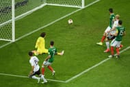 SOCHI, RUSSIA - JUNE 29: Amin Younes of Germany scores his side's fourth goal past Guillermo Ochoa of Mexico during the FIFA Confederations Cup Russia 2017 Semi-Final between Germany and Mexico at Fisht Olympic Stadium on June 29, 2017 in Sochi, Russia. (Photo by Matthias Hangst/Getty Images)