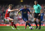 LONDON, ENGLAND - MAY 07: Anthony Martial of Manchester United attempts to take the ball past Rob Holding of Arsenal during the Premier League match between Arsenal and Manchester United at the Emirates Stadium on May 7, 2017 in London, England. (Photo by Laurence Griffiths/Getty Images)