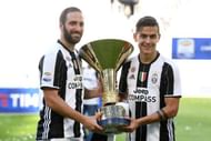 TURIN, ITALY - MAY 21: Gonzalo Higuain (L) and Paulo Dybala of Juventus FC celebrate with the trophy after the beating FC Crotone 3-0 to win the Serie A Championships at the end of the Serie A match between Juventus FC and FC Crotone at Juventus Stadium on May 21, 2017 in Turin, Italy. (Photo by Valerio Pennicino/Getty Images)