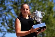 PARIS, FRANCE - JUNE 11: Jelena Ostapenko of Latvia, winner of the ladies singles final poses with the Suzanne Lenglen Trophy outside the Suzanne Lenglen statue on day fifteen of the 2017 French Open at Roland Garros on June 11, 2017 in Paris, France. (Photo by Alex Pantling/Getty Images)