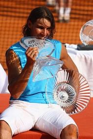 MONTE CARLO, MONACO - APRIL 27: Rafael Nadal of Spain bites the Masters Trophy after his 7-5,7-5 victory in the singles final match against Roger Federer of Switzerland on day nine of the Masters Series at the Monte Carlo Country Club, April 27, 2008 in Monte Carlo, Monaco. (Photo by Michael Steele/Getty Images)
