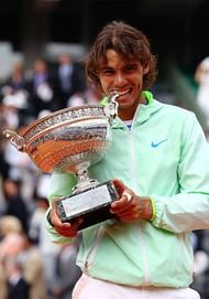 PARIS - JUNE 06: Rafael Nadal of Spain celebrates with the trophy after winning the men's singles final match between Rafael Nadal of Spain and Robin Soderling of Sweden on day fifteen of the French Open at Roland Garros on June 6, 2010 in Paris, France. (Photo by Julian Finney/Getty Images)