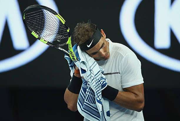 MELBOURNE, AUSTRALIA - JANUARY 19:  Rafael Nadal of Spain towels down in his second round match against Marcos Baghdatis of Cyprus on day four of the 2017 Australian Open at Melbourne Park on January 19, 2017 in Melbourne, Australia.  (Photo by Clive Brunskill/Getty Images)