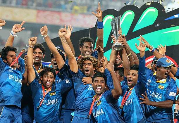 DHAKA, BANGLADESH - APRIL 06: Lasith Malinga of Sri Lanka and his team celebrate with the trophy on the podium after winning the Final of the ICC World Twenty20 Bangladesh 2014 between India and Sri Lanka at Sher-e-Bangla Mirpur Stadium on April 4, 2014 in Dhaka, Bangladesh. (Photo by Scott Barbour/Getty Images)