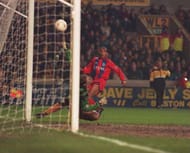 22 MAR 1995: CHRIS ARMSTRONG OF PALACE PUTS THE BALL PAST MICK STOCKWELL OF WOLVERHAMPTON TO SCORE HIS SECOND GOAL DURING THEIR FA CUP QUARTER-FINAL REPLAY BETWEEN WOLVERHAMPTON WANDERERS AND CRYSTAL PALACE PLAYED AT MOLINEUX STADIUM. THE MATCH ENDED INA 4-1 VICTORY FOR CRYSTAL PALACE. Mandatory Credit: Gary Prior/ALLSPORT