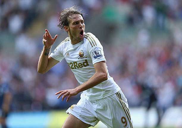 SWANSEA, WALES - AUGUST 25:  Michu of Swansea celebrates scoring the second goal during the Barclays Premier League match between Swansea City and West Ham United at the Liberty Stadium on August 25, 2012 in Swansea, Wales.  (Photo by Richard Heathcote/Getty Images)