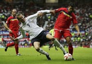 MANCHESTER, UNITED KINGDOM - SEPTEMBER 02: Peter Crouch (L) of England competes for the ball with Oscar Sonejee of Andorra during the Euro 2008 Qualifying match between England and Andorra at Old Trafford on September 2, 2006 in Manchester, England. (Photo by Laurence Griffiths/Getty Images)